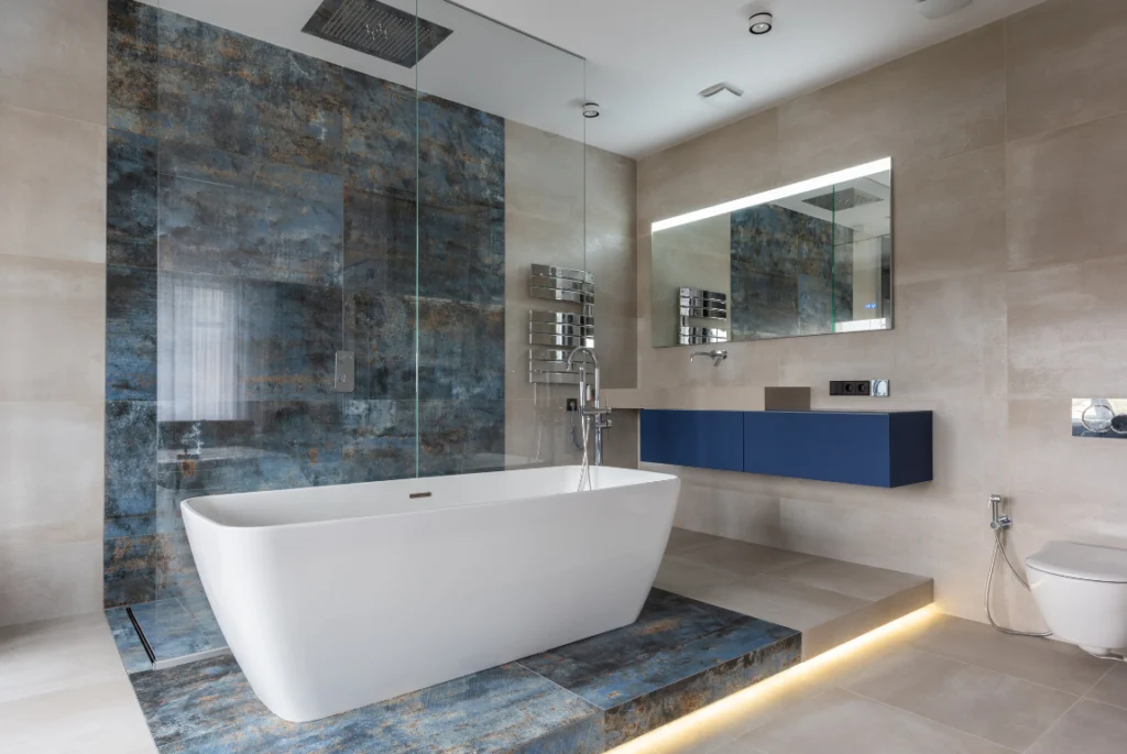 Bathroom Renovation Oasis Bathroom Boca Raton Modern bathroom renovation featuring a freestanding white bathtub, stylish blue cabinetry, and contemporary fixtures, showcasing a blend of aesthetics and functionality in a Boca Raton remodel.