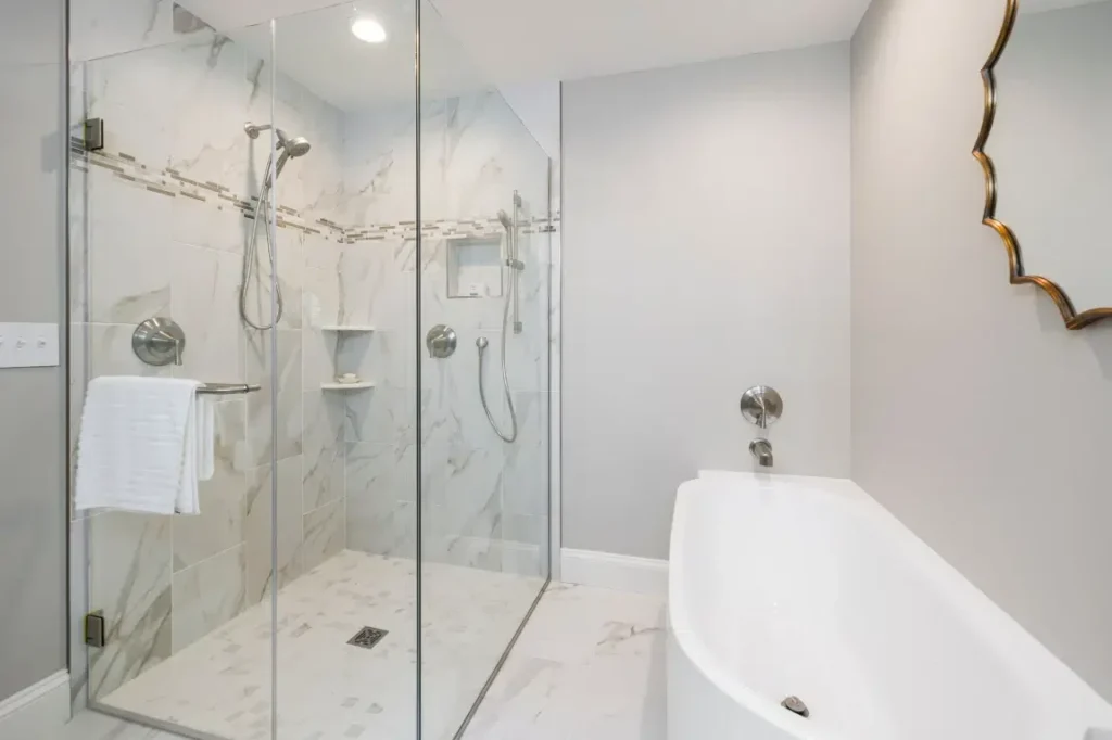 Luxury Small Bathroom Oasis Bathroom Boca Raton Luxury small bathroom design featuring a glass shower enclosure, modern fixtures, and a freestanding bathtub, emphasizing space-saving solutions and stylish aesthetics for compact spaces.