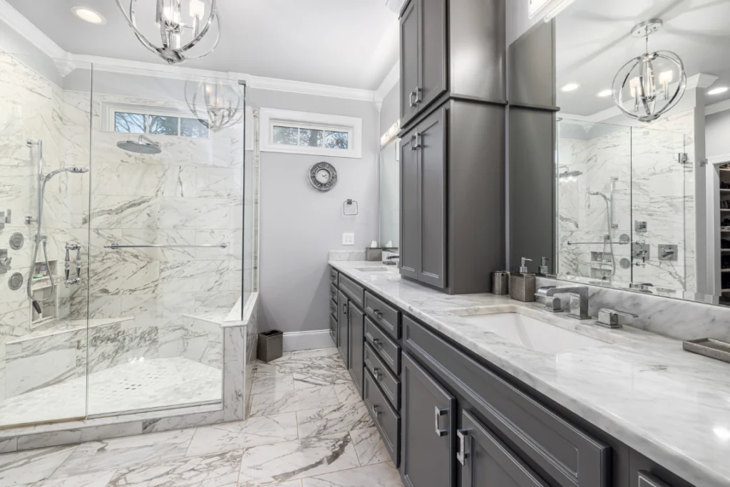 Modern Bathroom Renovation Oasis Bathroom Boca Raton Modern bathroom renovation featuring a sleek design with marble tile, glass shower enclosure, and stylish gray cabinetry, highlighting Oasis Bathroom Remodeling Boca Raton's expertise in creating functional and aesthetically pleasing spaces.