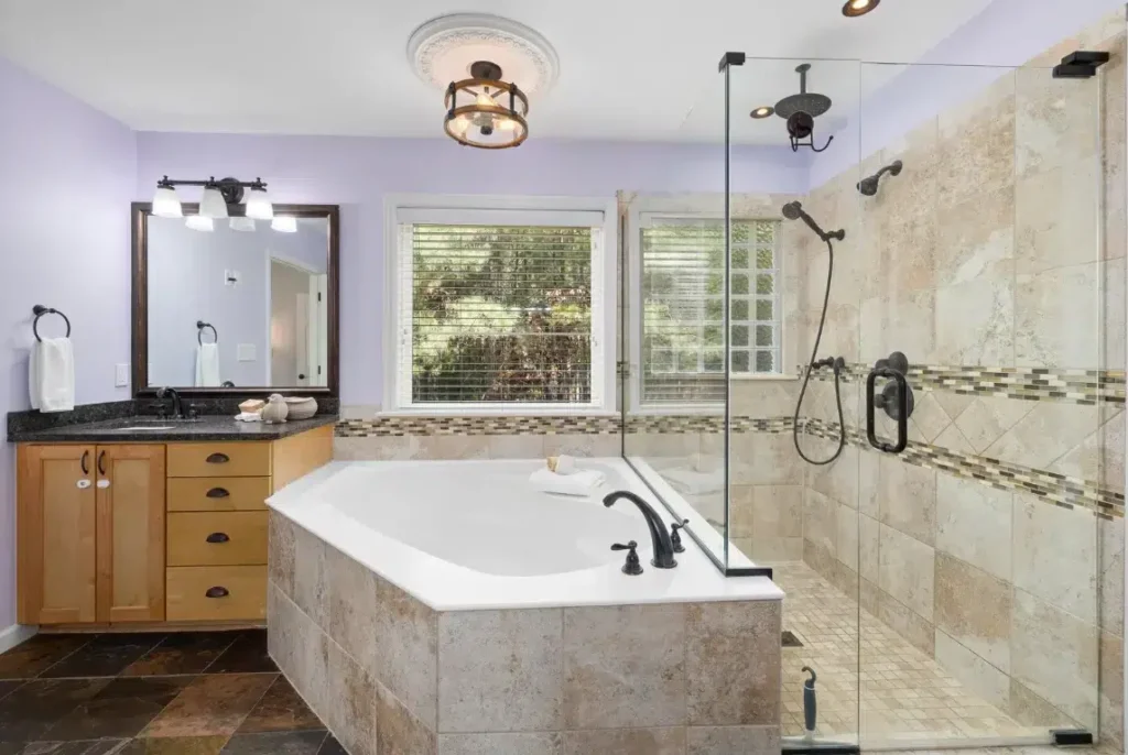 Modern bathroom featuring a stylish tub-to-shower conversion with glass enclosure, elegant fixtures, and a sleek design, showcasing the transformation potential for small spaces by Oasis Bathroom Remodeling Boca Raton.