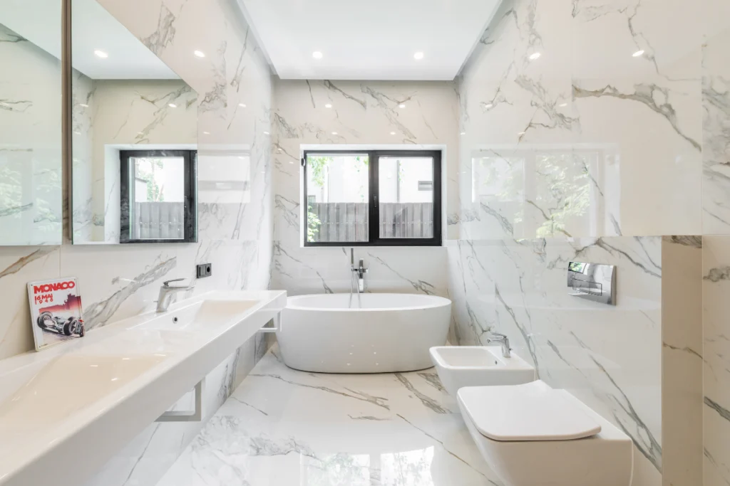 New Bathroom Remodel Oasis Bathroom Boca Raton Modern bathroom remodel featuring elegant marble walls, sleek double sink vanity, freestanding bathtub, and contemporary fixtures, showcasing Oasis Bathroom Remodeling's expertise in creating luxurious spaces.
