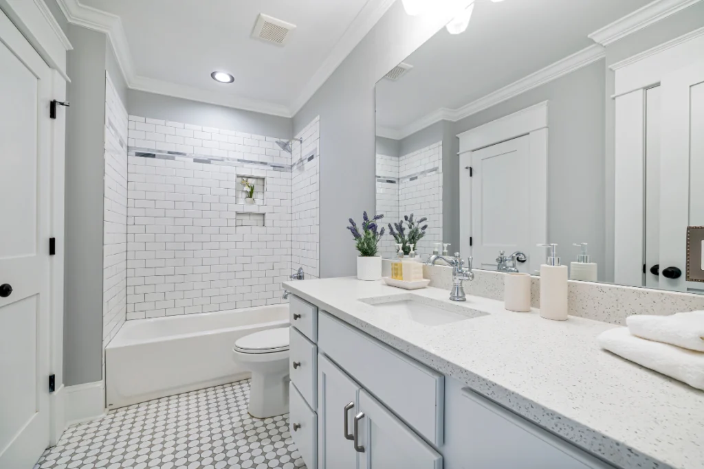 Modern bathroom interior featuring a stylish bathtub, white subway tile walls, and a sleek vanity with contemporary fixtures, emphasizing a fresh and functional design for bathroom remodeling.
